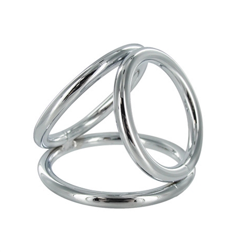 The Triad Chamber brings the art of domination in threes. This chrome cock cage features three differently sized O-rings with which you can ensnare your pet. The largest ring goes around the cock and balls like a normal cock ring. The middle sized ring goes around the balls providing the wearer with a pressure sensation. The third ring goes around the base of the penis to help you maintain the kind of erection that lasts for extended sessions. The Triad Chamber is perfect for the experienced user who wants a sleek and modern look but seeks a weighted more supportive cock ring. Large Ring: 2.05 inch internal diameter Medium Ring: 1.84 inch internal diameter Small Ring: 1.57 inch internal diameter Bands are 0.29 inches thick.