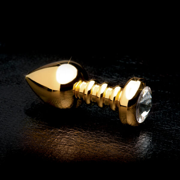 Enjoy incredible back door bliss with this elegant ribbed Luv Plug. The sleek plug is made of Pure Aluminium and is incredibly smooth nonporous and body-safe. The tapered tip eases insertion while the neck is perfectly ribbed for enhanced pleasure. The super hygienic Pure Aluminium is great for  water-based temperature play and is small enough to take with you wherever you go. The wide crystal-adorned base ensures safe and easy removal but while its inserted the only thing your lover will see is the beautiful sparkling crystal.