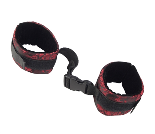 Forced positioning between trusting lovers is an incredibly sensual part of bondage love-play. A set of cuffs joined at the middle by a graspable handle provides support and leverage for deep penetration placing control firmly in the dominant partners hand.