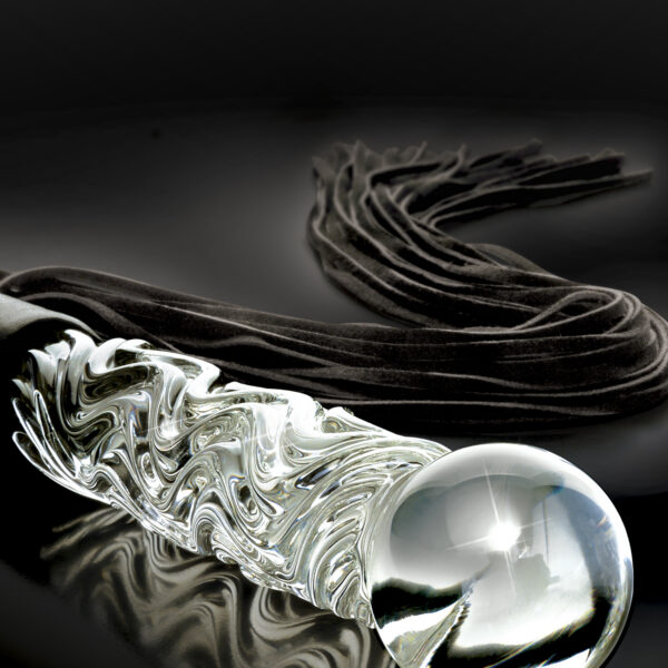 Elegant upscale and hand-crafted with amazing attention to detail this luxurious glass flogger will leave you breathless. Each hand-blown Icicle glass is sleek unique and made to play hard. The hypoallergenic glass is nonporous and body safe and when cared for properly is designed to last a lifetime. The glass Cat-O-Nine Tails features genuine bull leather tresses that are soft enough for begginer play but heavy enough to deliver a firm whack. The heavy-duty weighted glass handle is hand-blown and doubles as a glass dildo for vaginal and anal play. The beautiful textured swirls provide added stimulation and the glass handle can be heated or cooled for tempting temperature play. <br><br> Length: 26.5" (67.5 cm) <br> Insertable Length: 6.75" (17 cm) <br> Width: 1.5" (3.8 cm)